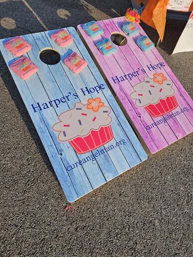 Cornhole boards and bags with Harper's Hope on them at the event
