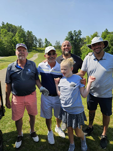 Harper with golfers at the event